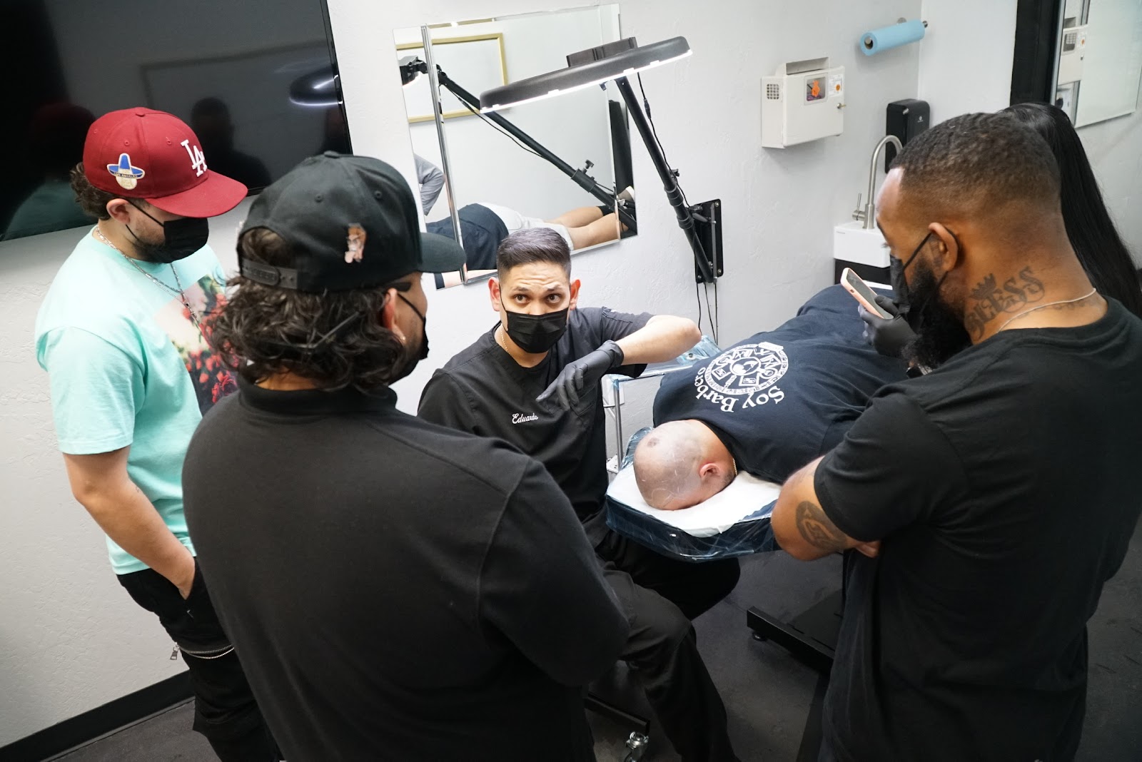 A scalp micropigmentation session in our studio, the hairline mapped out under the ring light
