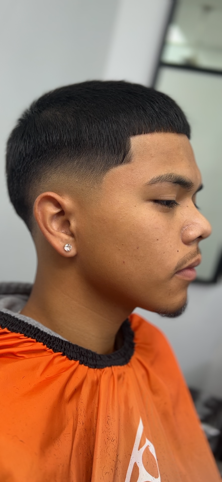 Fresh taper fade with a crisp lineup, just finished in our chair